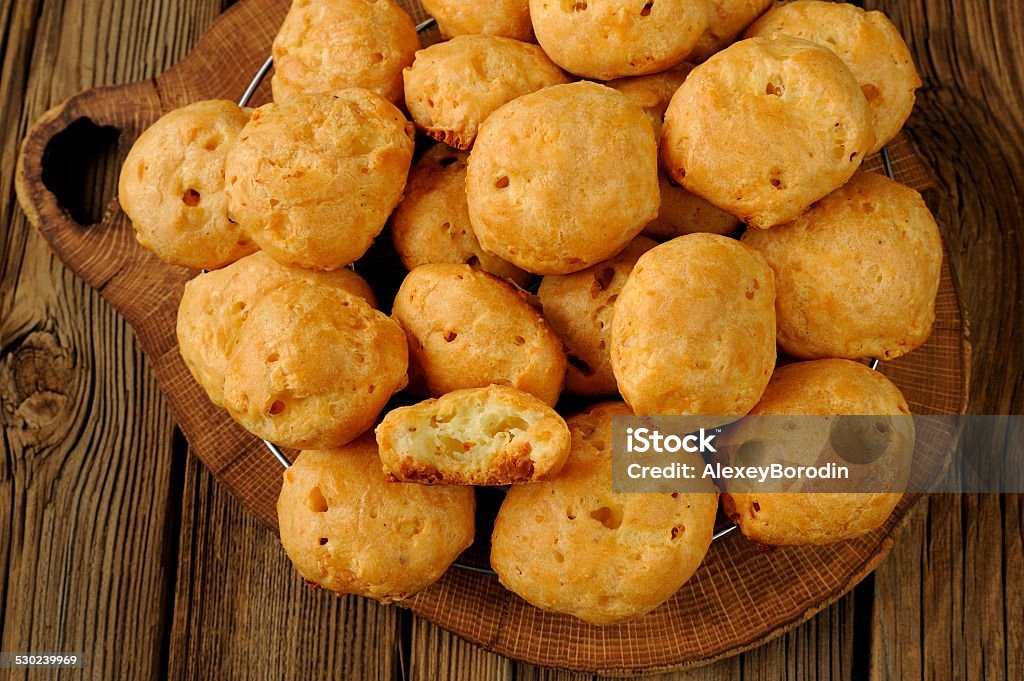 Gougeres on wooden background Gougeres on wood board with wooden background Baked Pastry Item Stock Photo