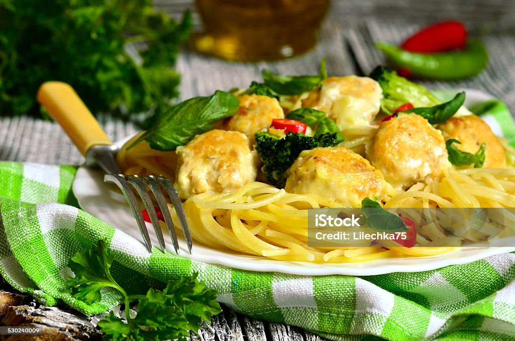 Spaghetti with chicken meatballs and broccoli. Spaghetti with chicken meatballs and broccoli in bechamel sauce. Basil Stock Photo