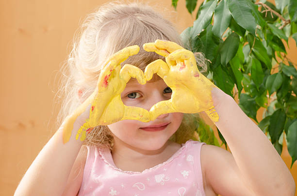 blond girl with yellow painted hands