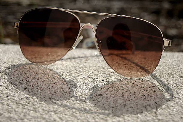 istock Gold rimmed sunglasses with shadow 530240737