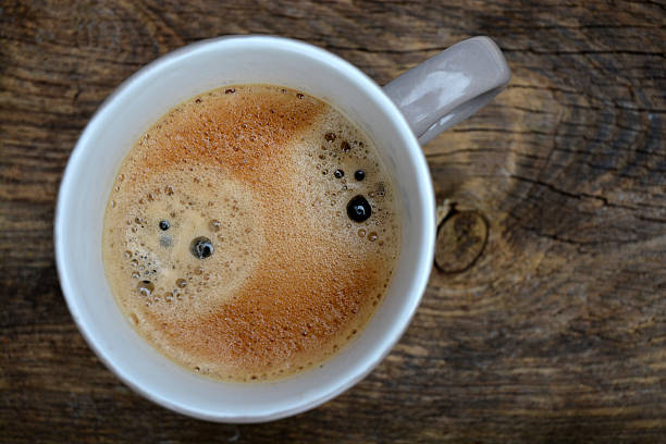 istock Grey Coffee cup on old used wood with coffeefoam 530241397