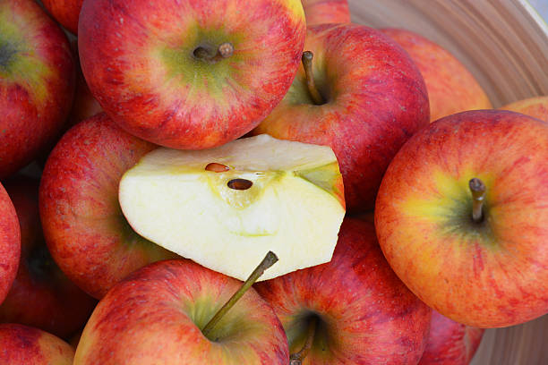 istock apples in a green fruit bowl on wooden background 530246491