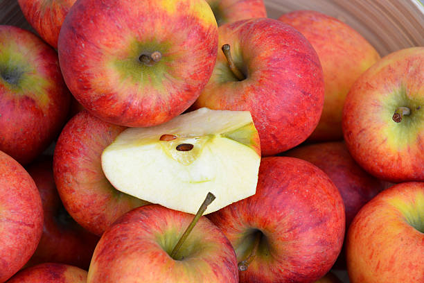 istock apples in a green fruit bowl on wooden background 530246497