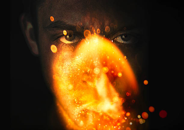 Flame ignites in front of mans face portrait