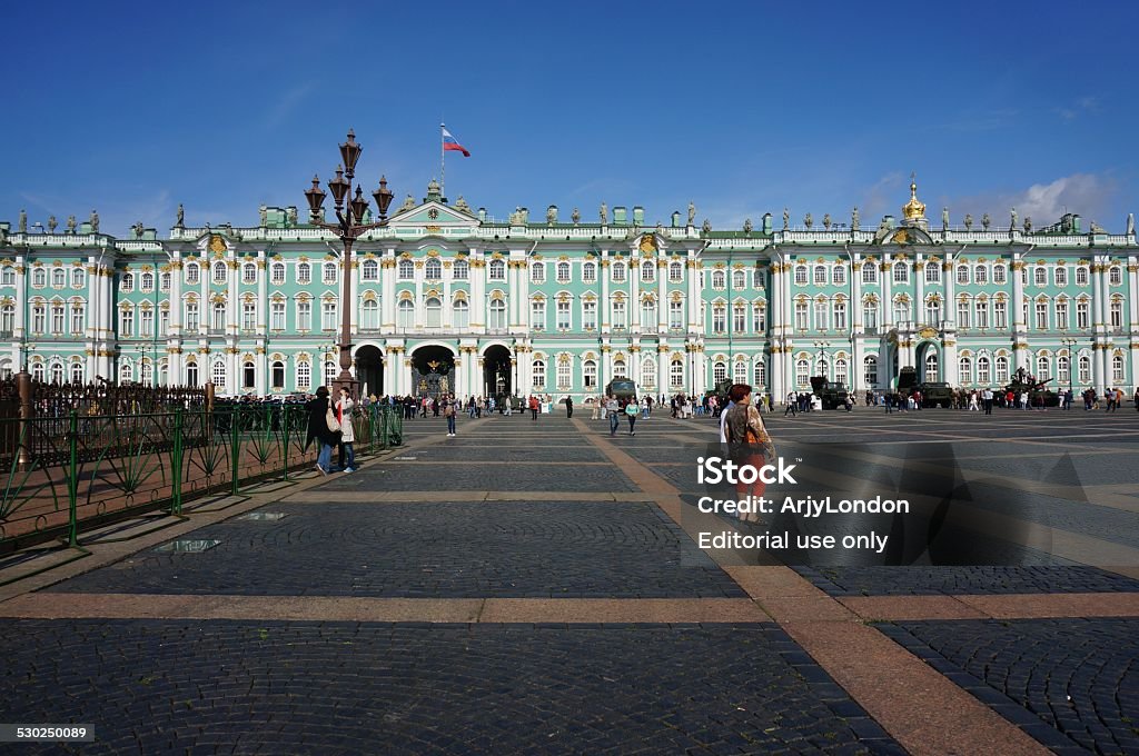 Palace Square, St. Petersburg St. Petersburg, Russia, 23rd August 2014: Palace Square in early morning sunshine, with tourists passing through, and the Hermitage Museum (Winter Palace) in the background Horizontal Stock Photo