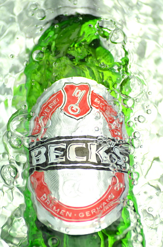 Kwidzyn, Poland – JULY 12, 2014: Becks beer in splashed water. Becks brewery was founded in 1873 in Bremen, Germany.