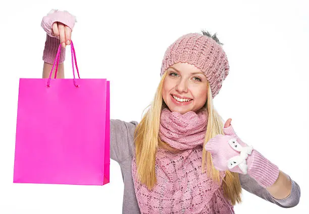 Photo of Smiling teenager girl showing shopping bag and thumbs up