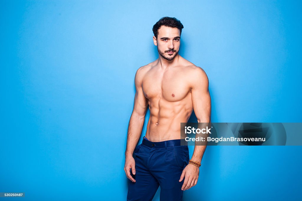 shirtless man with beard on blue background 30-34 Years Stock Photo