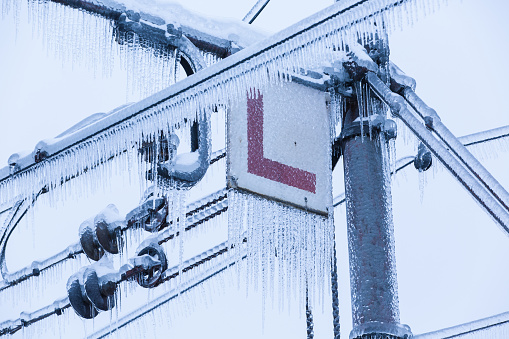 Frozen electrical lines for railroad with icicles