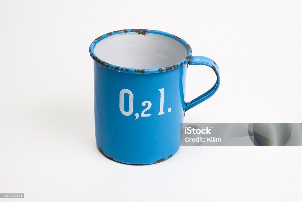 enamel measuring jug small blue enamel jug standing on a white background 1900 Stock Photo