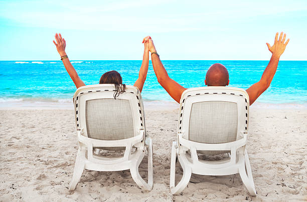 istock Couple relaxing on sunbed 530257917