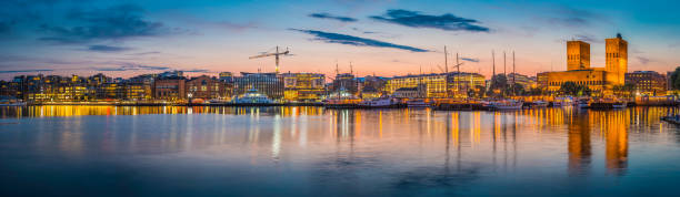 istock Oslo waterfront illuminated dusk City Hall harbour Aker Brygge Norway 530258117
