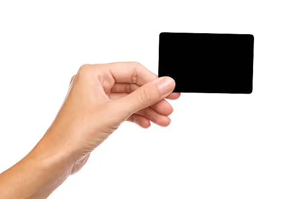 Close up of woman's hand holding blank black card. Studio shot isolated on white.
