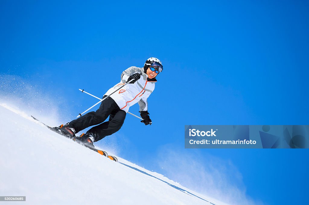 Men snow skier skiing on sunny ski resorts  Winter sport Vital senior men snow skier, equipped with modern carving ski equipment. Skiing  enjoying on sunny ski resorts. Skiing carving at high speed.  Snow in the foreground, sky in the background, applicable for all ski resorts and locations. Shot with Canon 5DMarkIII, developed from RAW,  Adobe RGB color profile. Shallow DOF  for soft background. Activity Stock Photo