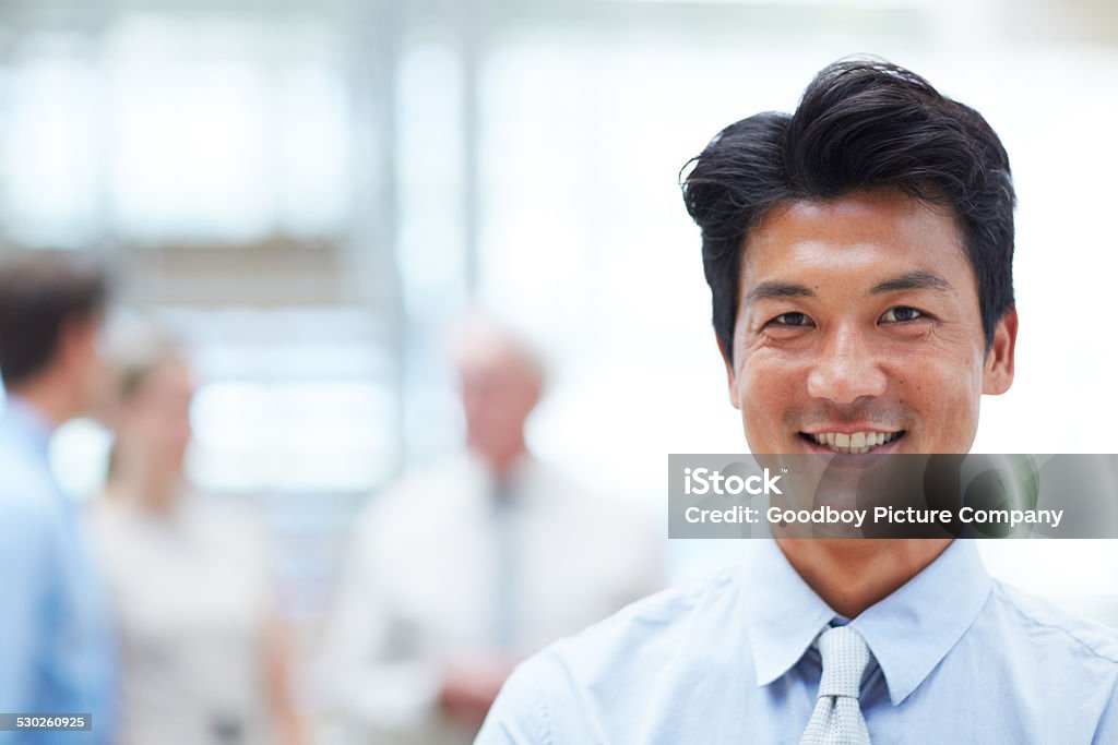 His confidence will get him to the top Portrait of a handsome businessman with his colleagues standing in the background Adult Stock Photo