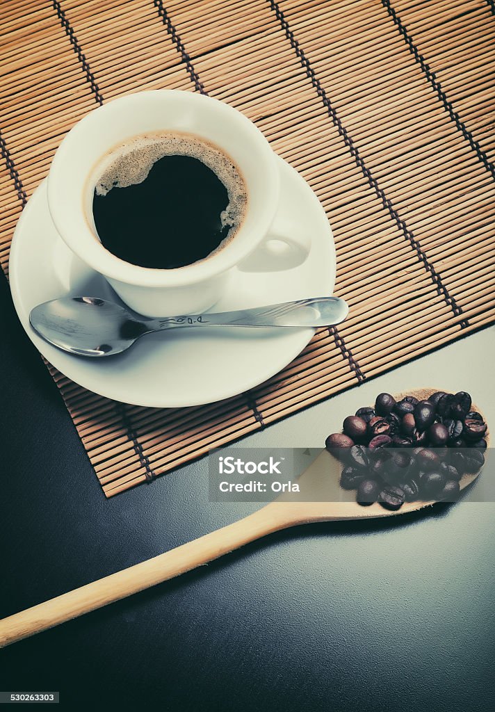Cup of coffee Close up of a white cup of coffee and a wooden spoon with beans Abundance Stock Photo