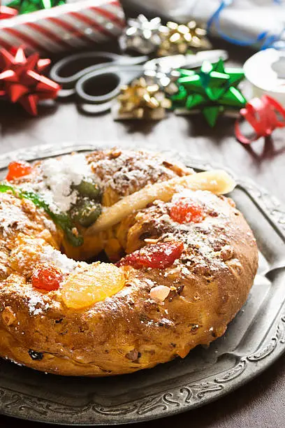 A popular cake during the Christmas season, Bolo do Rei (or Bolo Rei) is round with a hole in the center and both topped and filled with candied fruit and nuts. Usually a single dried fava bean is baked into the cake and the person who gets this bean in their slice is considered the winner. This person usually gets some sort of prize as well as having to be the one to buy the next year's Bolo Rei. 