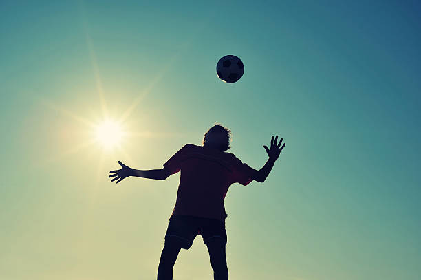 istock Boy playing football on beach 530264577