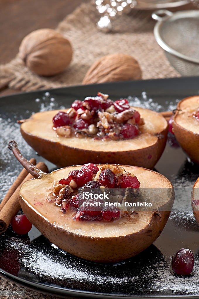 Baked pears with cranberries, honey and walnuts Autumn Stock Photo
