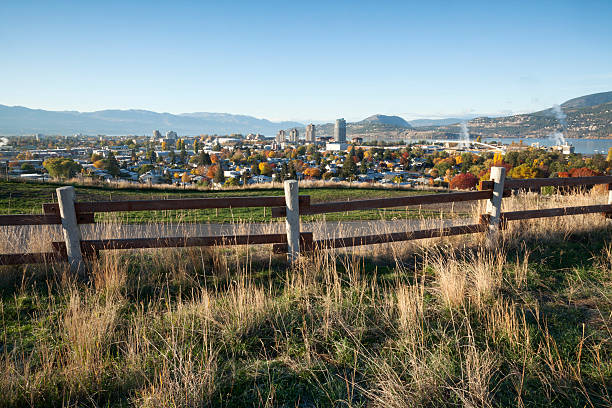Kelowna British Columbia, Okanagan Knox Mountain early morning sunrise Early morning light hitting beautifull Kelowna, British Columbia from Know Mountain. Autumn and fall colors. This image was taken from a tripod, iso 100, 20 mm lens, f22, 1/6th sec. Fence in the foreground. kelowna-autumn stock pictures, royalty-free photos & images