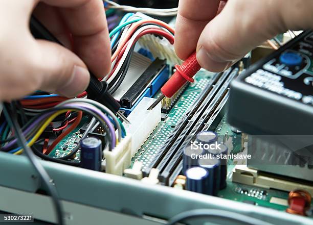 Closeup Of A Technician Hands With Multimeter Stock Photo - Download Image Now - Digital Clock, Repairing, Cable