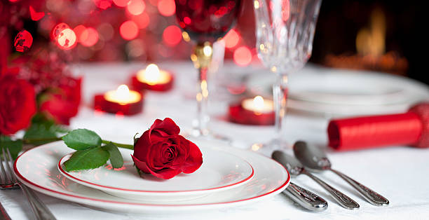 istock Valentines day red roses, dining table, candles and fireplace 530273491