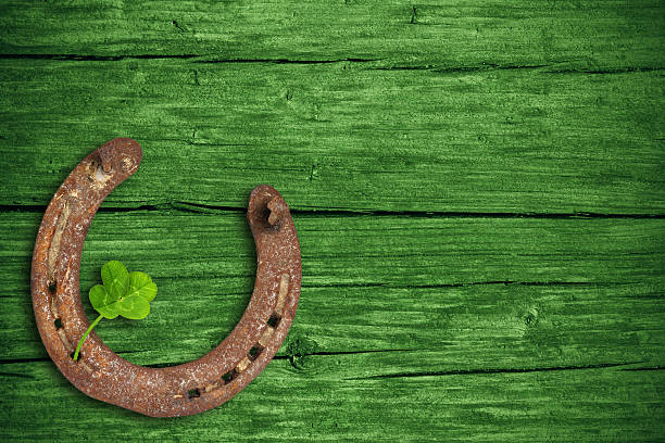 St. Patricks day, lucky charms Lucky charms, horse nail and four-leaf clover with green wooden background, st patricks day. horseshoe horse luck good luck charm stock pictures, royalty-free photos & images