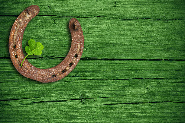 St. Patricks day, lucky charms Lucky charms, horse nail and four-leaf clover with green wooden background, st patricks day. horseshoe horse luck good luck charm stock pictures, royalty-free photos & images