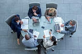 Businesspeople shaking hands at conference table