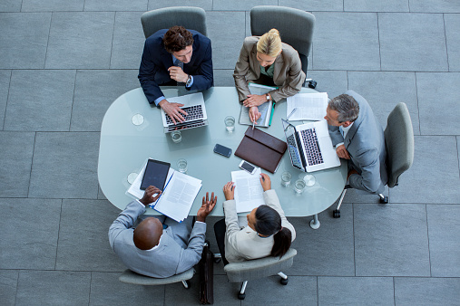 High angle view of business professionals discussing strategy at conference table in office