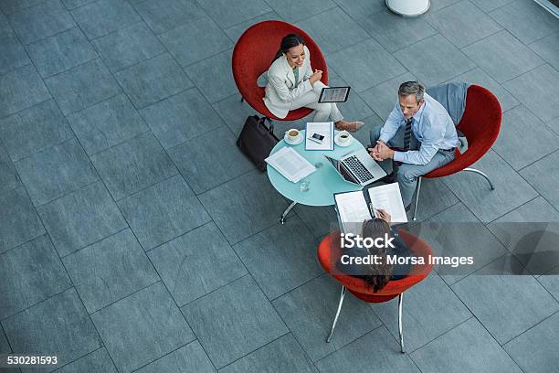 Businesspeople Discussing Strategy At Coffee Table Stock Photo - Download Image Now - Business Meeting, Business, Business Person