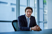 Confident businessman sitting at conference table