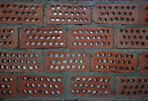 istock Red brick wall background with honeycombed holes 530283551