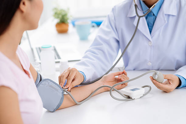 Checking blood pressure Doctor checking blood pressure of the patient, selective focus general military rank stock pictures, royalty-free photos & images