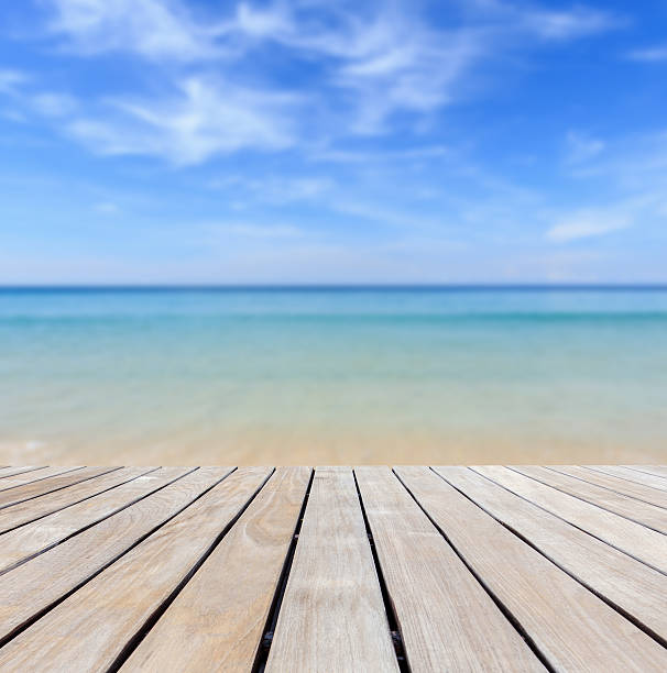 istock Grey wood decking and tropical beach 530284623
