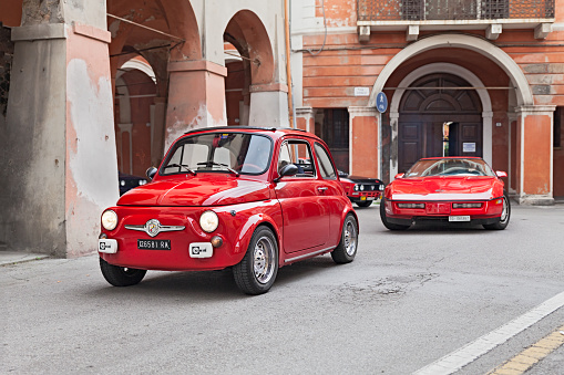 Bagnacavallo, RA, Italy - November 10, 2013: red vintage car Fiat 500 runs along the city during the rally 