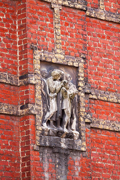Brussels, Belgium - July 21, 2012: Relief with children in Brussels, detail of red brick facade. Seen in district close to Koninklijke Vlaamse Schouwburg in old Brussels.
