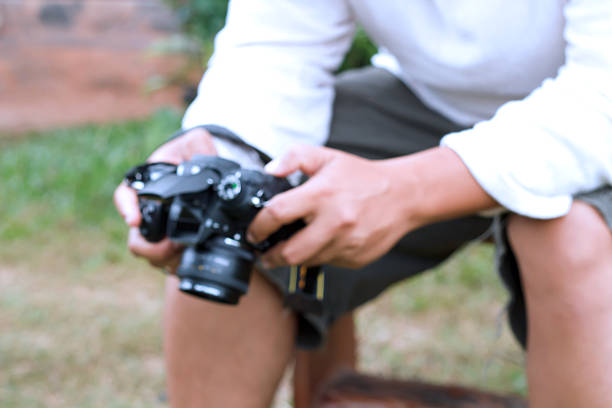 istock Blurred man selected photoes on his camera. 530288035