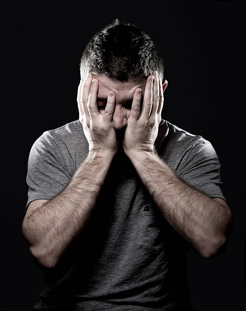 istock man suffering migraine and headache sick with hands on tempo 530290229