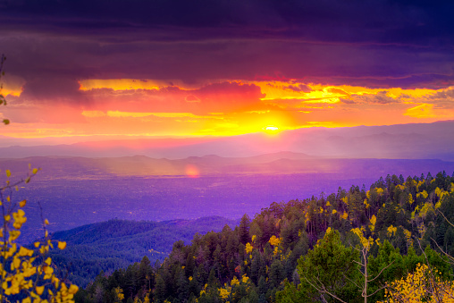 New Mexico fall mountain sunset  featuring golden aspens and rays of sunlight