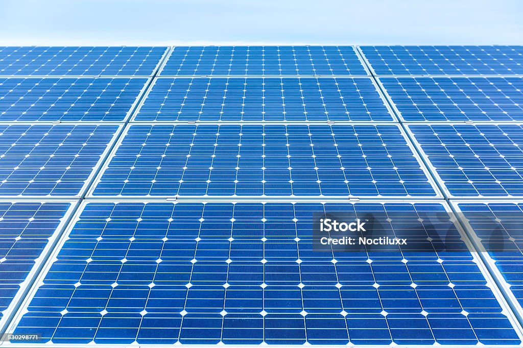 Solar panels generating clean energy Solar panels generating clean electricity reducing environmental pollution Blue Stock Photo