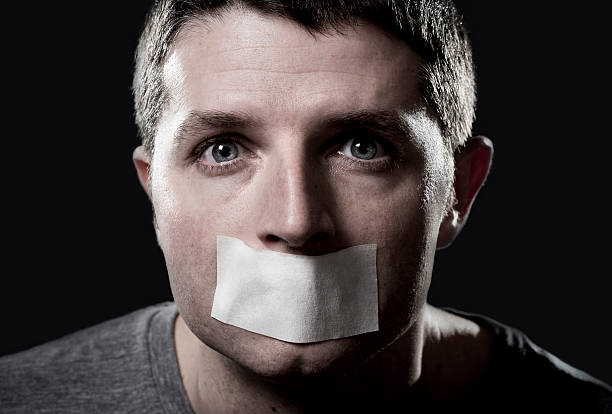 istock attractive young man  mouth sealed on adhesive  tape 530299607
