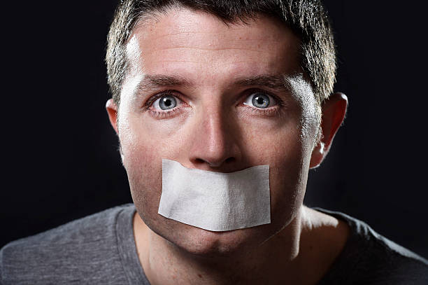 istock attractive young man  mouth sealed on adhesive  tape 530299655