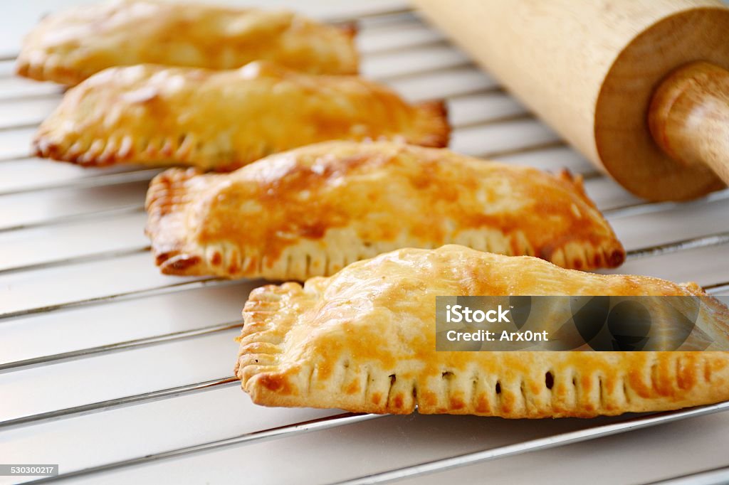 Freshly baked small hand pies or pastries on baking tray Homemade pastry pies on baking tray Arts Culture and Entertainment Stock Photo