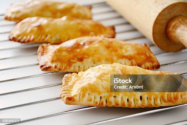 Freshly Baked Small Hand Pies Or Pastries On Baking Tray Stock Photo - Download Image Now