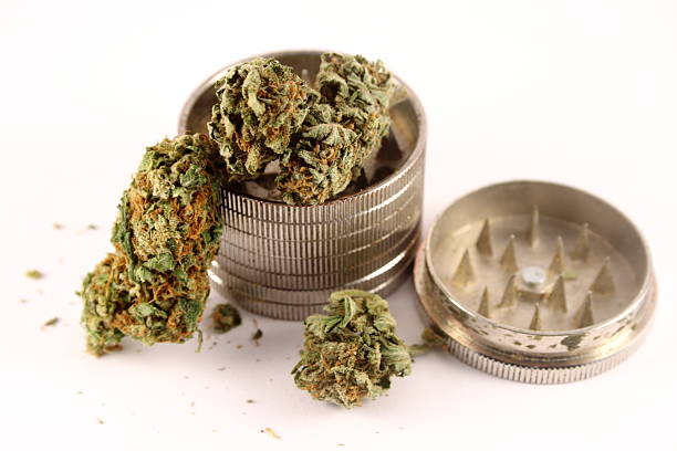 istock Cannabis in metallic grinder on white background 530306627