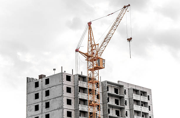 istock big yellow crane constructing a new high rise 530307979