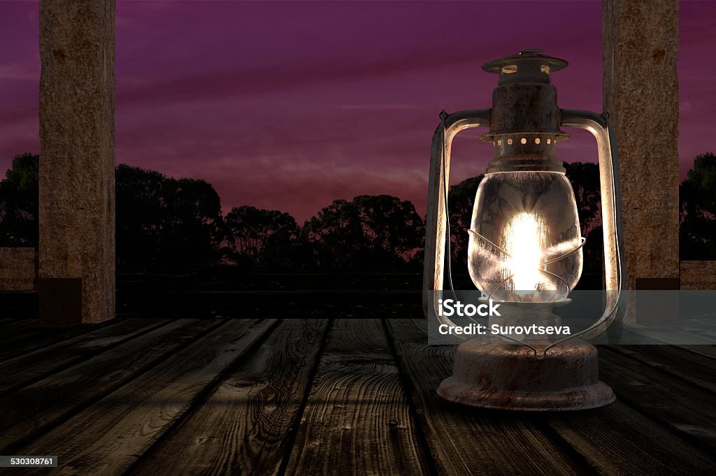 Kerosene lantern Kerosene lantern on a wooden porch against a sunset background Porch Stock Photo