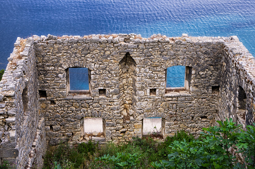 Old and ruined house in front of the sea, in Ithaca island, Greece