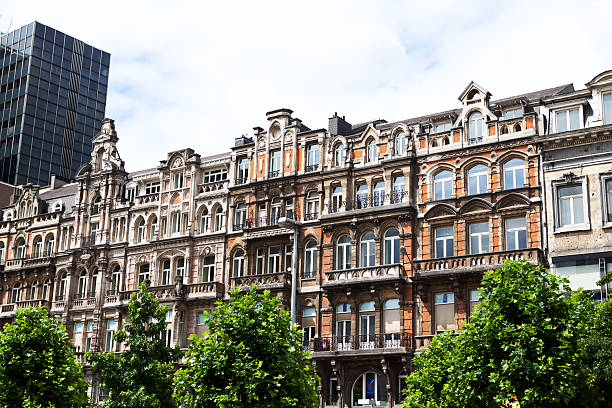 Rowhouses and facades from 19th century in Brussels Brussels, Belgium - July 21, 2012: Rowhouses and facades from 19th century in Brussels on street Boulevard Anspach in summer. houses in brussels stock pictures, royalty-free photos & images